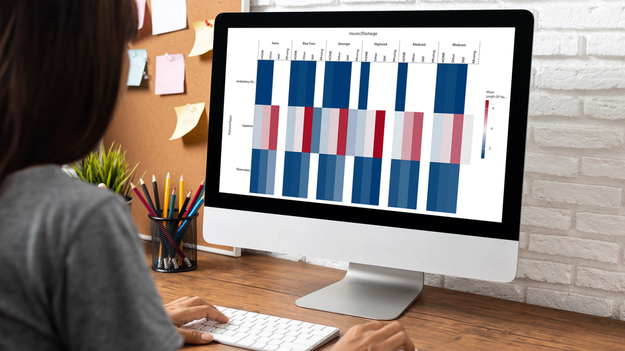 woman working empty screen computer on wood desk in home office.